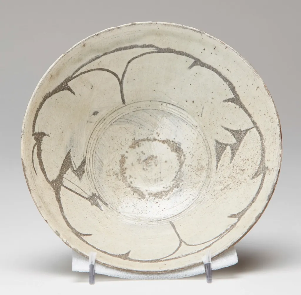 An aged, imperfect ceramic bowl