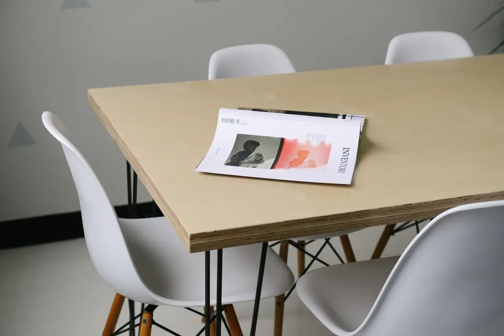 A light-wood dining table styled with ceramics