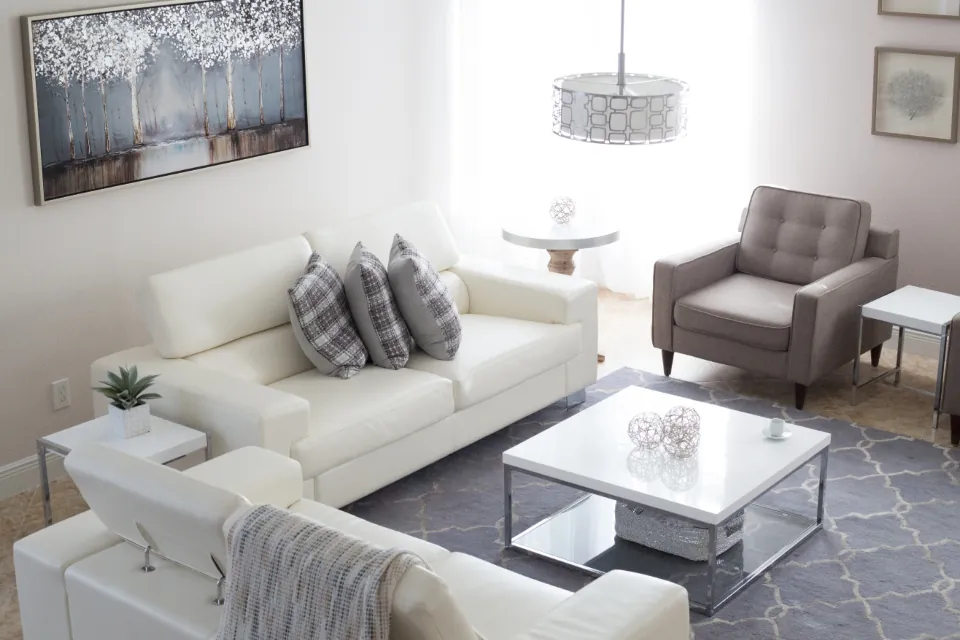 Doma living set — a low modular sofa in natural linen with a wooden side table