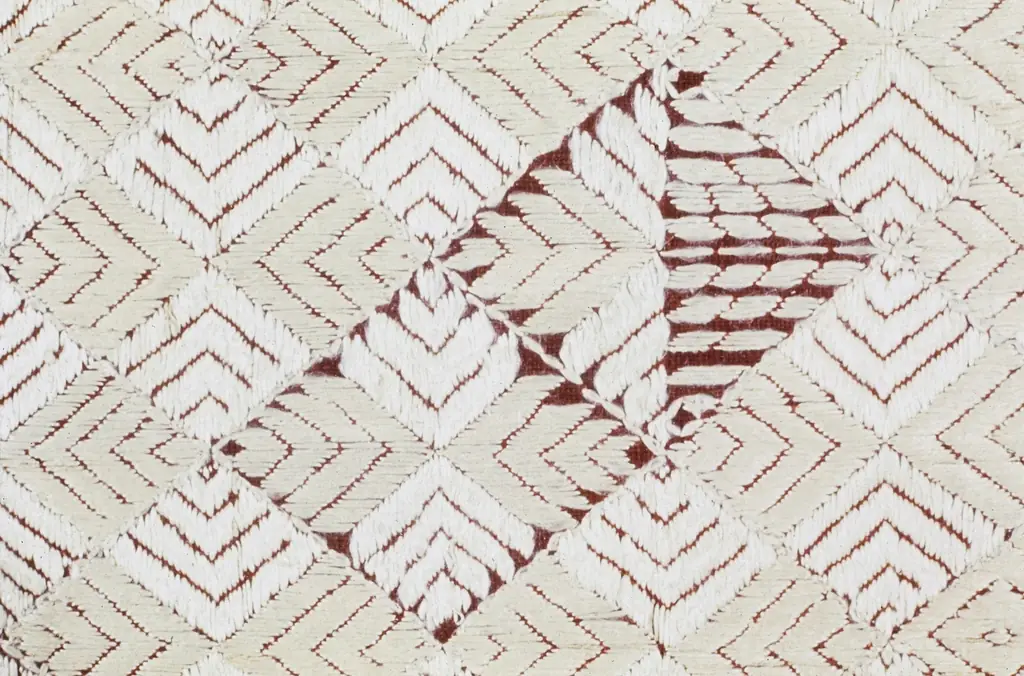 Hand-stitched shibori textile in rust and cream